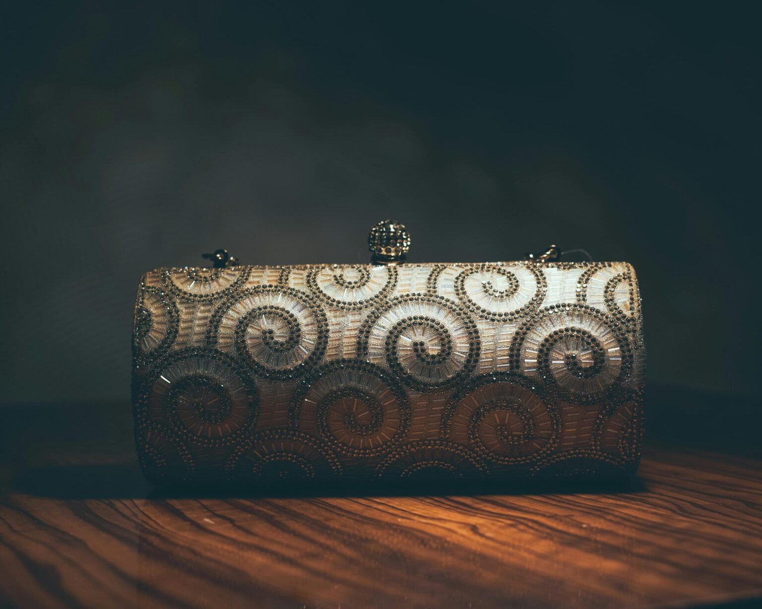 A luxurious beaded clutch purse featuring an intricate swirl pattern, perfect for evening events.